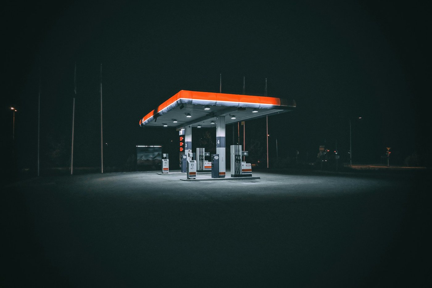 A fuel station forecourt lit up at night