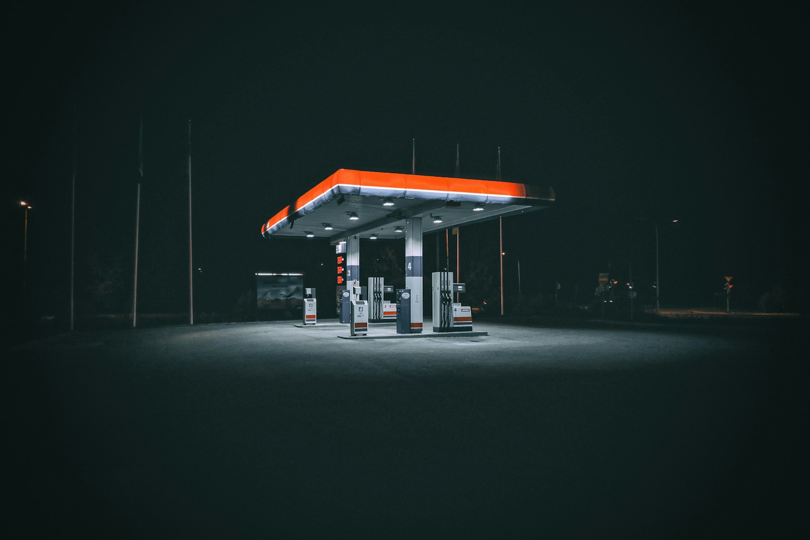 A fuel station forecourt lit up at night