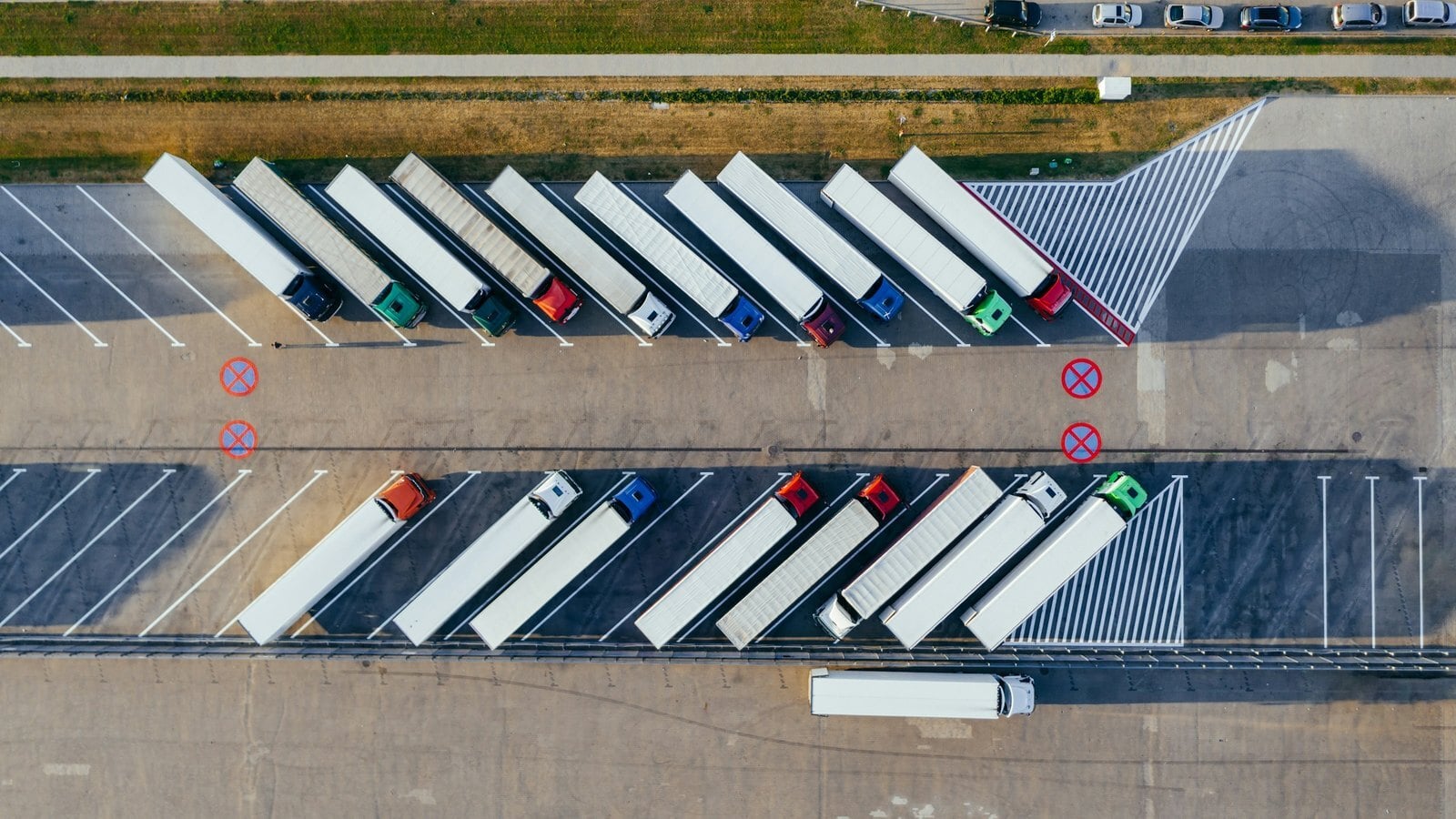 Aerial view of semi-trailers parked in rows at a truck yard