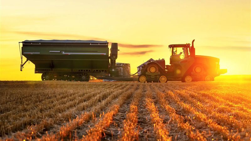 Tractor and grain cart working a harvested paddock