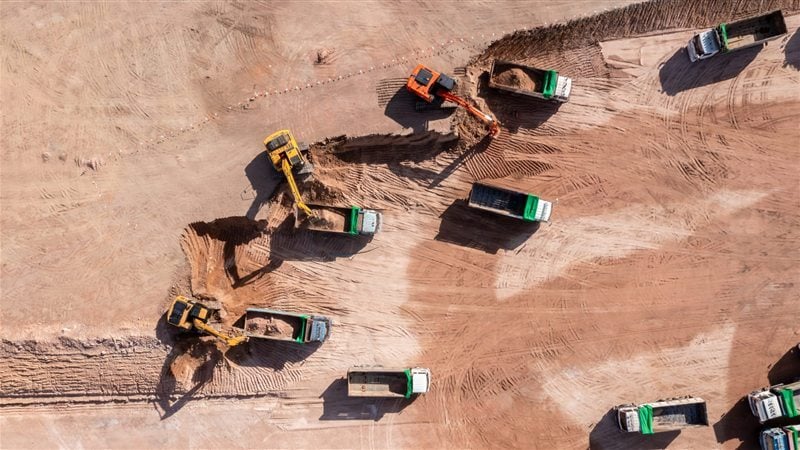 Excavators loading haul trucks on an earthworks site
