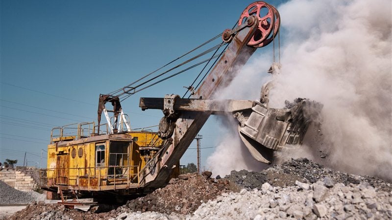 Excavator loading at a mine face