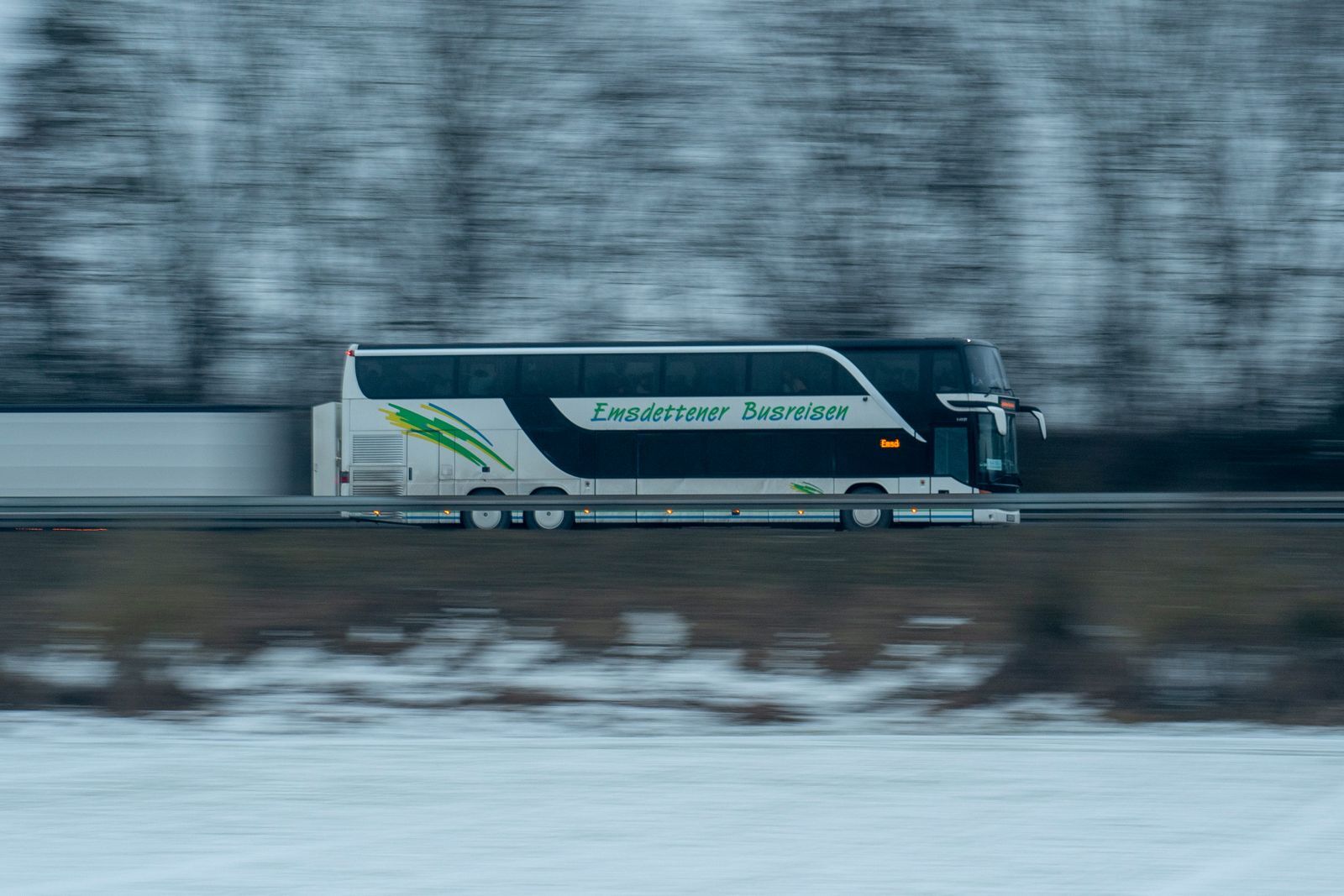 Coach on a highway with mountains behind