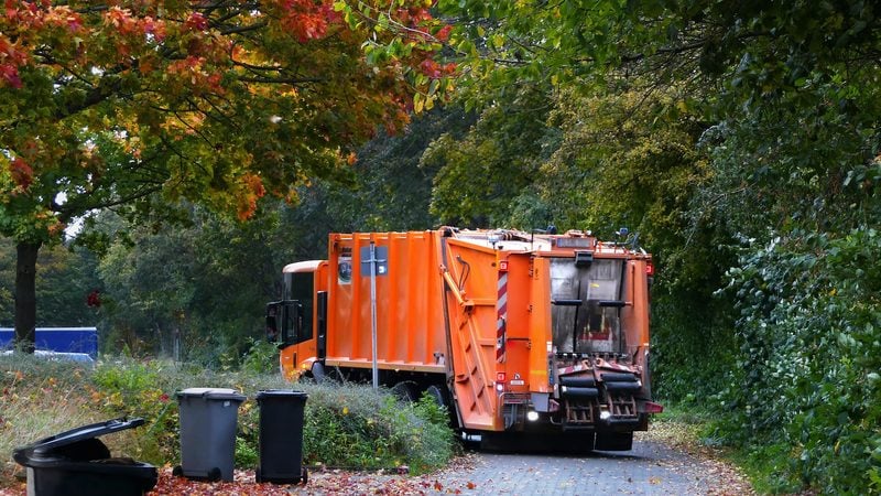 Rear loading refuse truck on a collection round